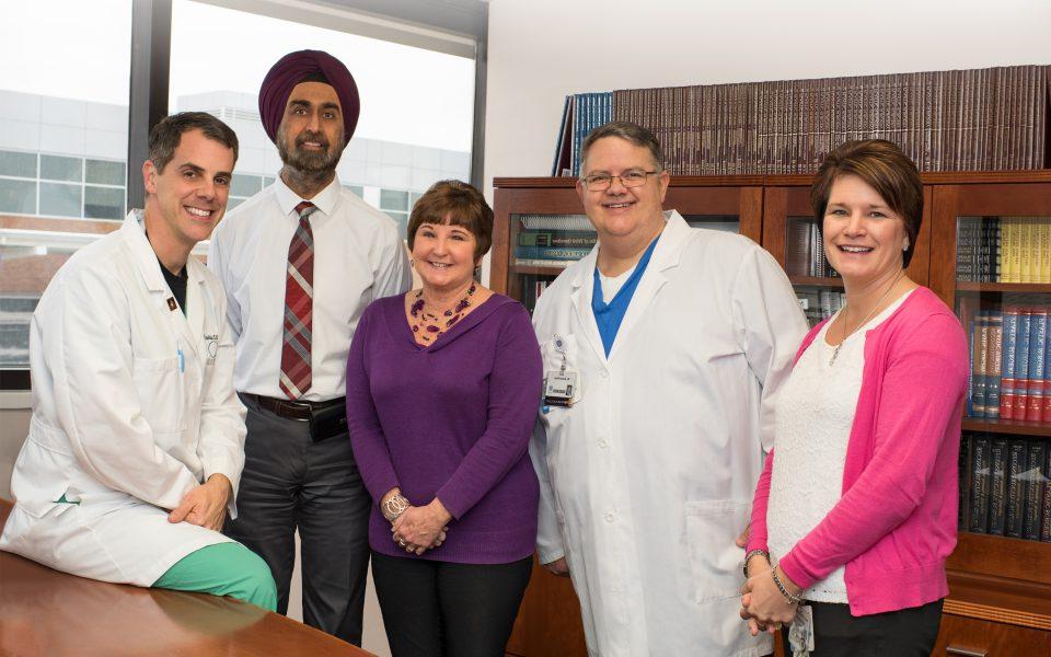 Female cancer survivor with her team of providers